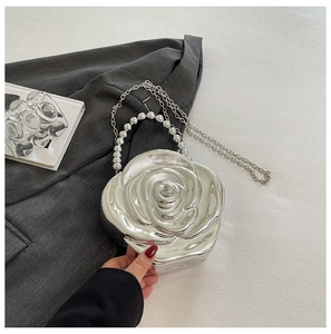 Detailed view of silver rose acrylic evening bag with beaded handle and chain strap