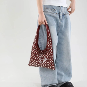 Fashionable dark red moon bag with silver rivets and glossy finish for modern women