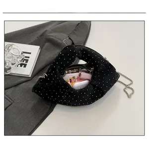 Polka dot handbag showing interior capacity with essentials on a chic blazer background