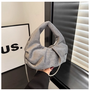 Detail view of a gray crescent hobo bag with sparkling silver rhinestones and chain strap