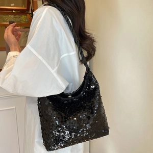 Chic black sequin shoulder bucket bag with braided strap shown on model in bright setting