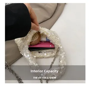 Detail view of white sequin chain bag showing internal capacity for daily essentials