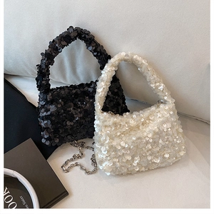 Detail of sequined handbags in black and white with detachable silver metal chain straps