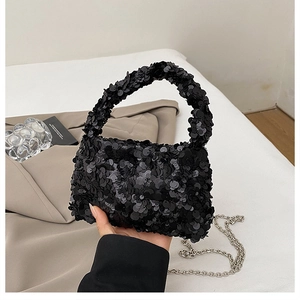 Detail of black sequin cloud bag with silver chain strap and top handle design