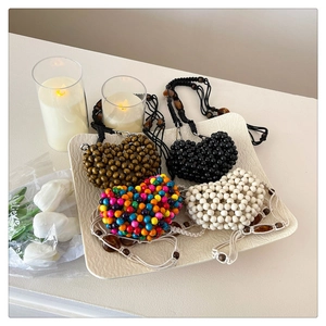 Handmade beaded heart-shaped mini crossbody bags in assorted colors for summer fashion