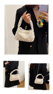 Detail of white sequin cloud bag featuring metallic chain strap and thick handle grip