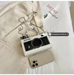 Camera-shaped shoulder bag in cream white with silk scarf handle and chain strap detail