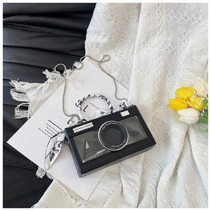 Detail view of black camera shaped crossbody bag with floral scarf handle and crystal trim