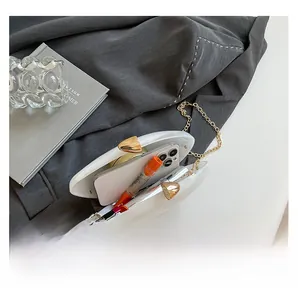 White shell acrylic evening bag interior showing space for phone and lipstick