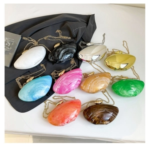 Collection of shell-shaped acrylic evening bags in ten glossy candy colors with gold chains