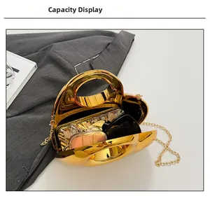 Detailed view of golden heart-shaped acrylic bag showing inner capacity for cosmetics