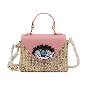 Sac à main en paille avec rabat en cuir rose, broderie œil et pampilles de strass