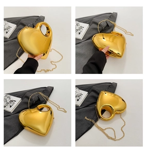 Detail shots of a gold heart-shaped acrylic handbag with mirror finish and chain strap