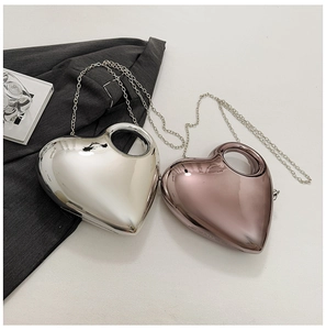Detail of heart-shaped acrylic evening bags in mirror silver and rose gold finishes