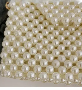 Macro shot of intricately woven ivory pearls with elegant gold metal hardware detail