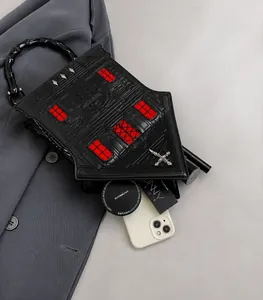 Top view of the goth house-shaped bag interior showing space for makeup and phone