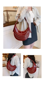 Détail du sac à bandoulière rouge en forme de croissant avec rivets punk et sangle