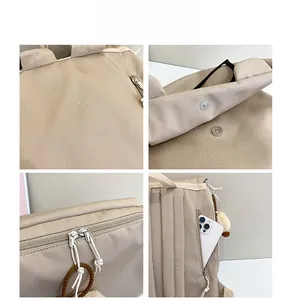 Detail view of beige water-repellent fabric, magnetic flap and side zipper pocket