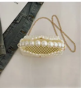 Macro shot of handmade pearl woven bag showing interior space and gold chain strap detail