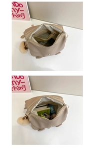 Internal view of the beige nylon backpack showing large capacity and zipper pocket