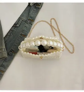 Detail of white pearl beaded bag interior showing space for phone and cosmetics