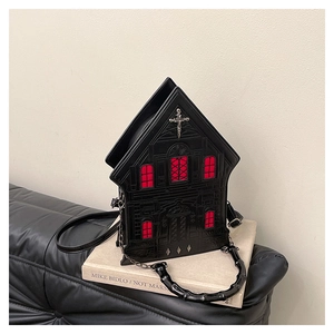 Detailed texture of Gothic house-shaped PU handbag with red windows and silver cross