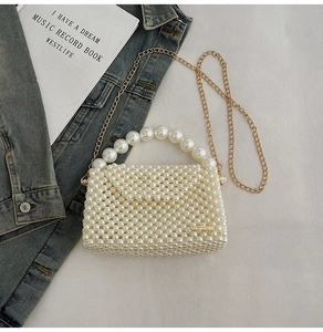 Detailed view of handmade white pearl woven mini bag with gold chain and top handle