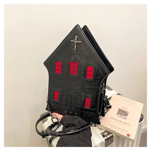Detailed view of Gothic house-shaped PU handbag with red window accents and metal cross