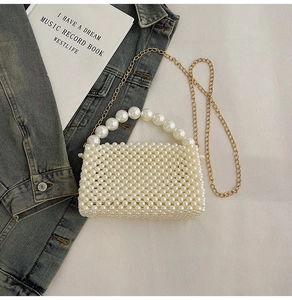 Detail of hand-woven pearl mini bag featuring large pearl handle and gold chain strap
