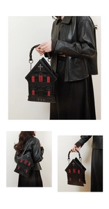Gothic architectural handbag with red window detail and metallic cross on black leather