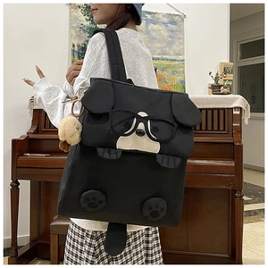 Detail of cute 3D cartoon dog backpack with plush ears and glasses in lifestyle setting