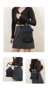 Gothic church-shaped handbag featuring cross detail and blue window accents shown on model