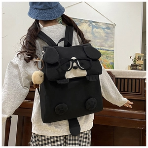 Detailed view of black cartoon dog backpack with 3D ears and cute glasses decor