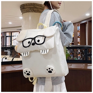Detail view of cartoon dog backpack with 3D ears and tail on high-density white canvas