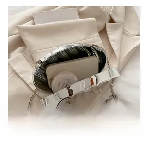 Silver metallic oval clutch bag with interior space for phone and cosmetics