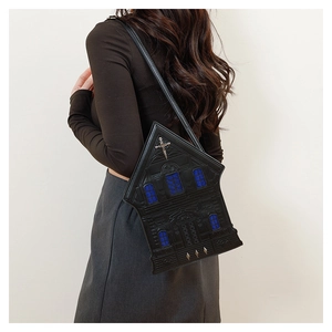 Gothic church shaped crossbody bag with metallic cross and blue window details on model