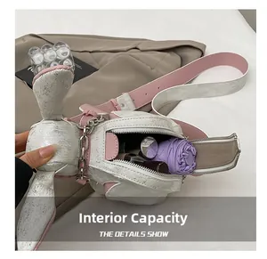 Interior view of white rabbit crossbody bag showing capacity for umbrella and cosmetics