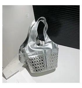 Detail shot of silver metallic leather tote bag with dense circular rivet studs