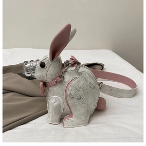 Detailed close-up of rabbit bag showing silver faux leather texture and pink details