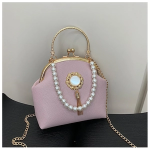 Pink lychee texture handbag with golden round handle and elegant pearl strap detail