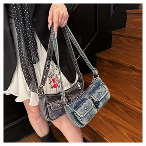Close-up of vintage washed denim crossbody bags with dual pockets and red apple charm