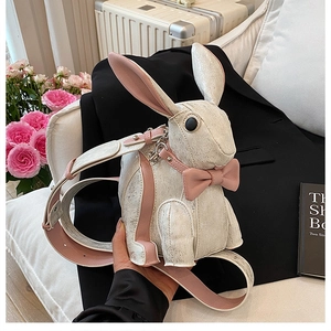 Close-up of bunny shaped bag featuring vintage crackle texture and pink bow detail