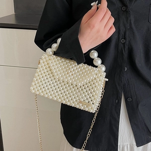 Fashionable woven pearl handbag with top handle and gold chain strap for women