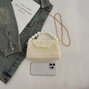 Elegant white handmade pearl woven handbag with gold chain strap and top handle