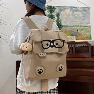 Cute Japanese style khaki dog-shaped backpack with 3D ears and plush pendant on model