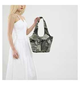 Macro detail of camouflage tote bag with metallic silver stud embellishments