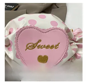 Close-up of sweet pink heart embroidery with gold Sweet lettering on white polka dot bag