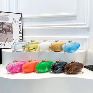 Luxury acrylic pebble evening clutch bags in vibrant colors with marble texture and gold chain