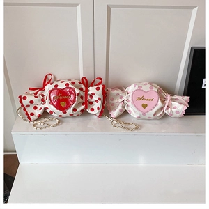 Detail of candy-shaped bags with red and pink polka dots and heart-shaped sweet prints