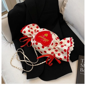 Detail of candy-shaped crossbody bag with red polka dots and sweet heart embroidery